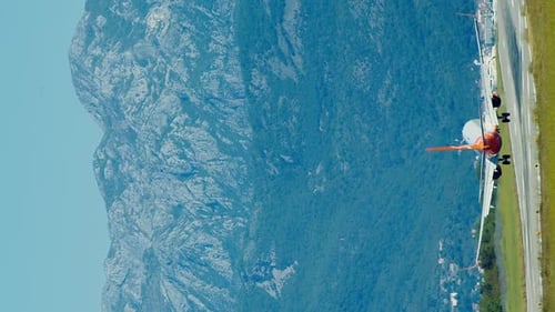 Vertical video huge plane landing in mountains of Montenegro in Tivat airport