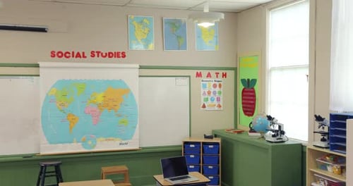 Empty school classroom jib down revealing desks in preparation for students