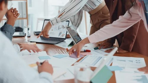 Documents, laptop and business people in office with finance graphs, charts or statistics