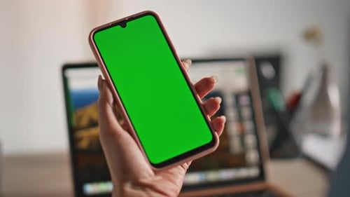 Hand Holding Smartphone with Green Screen