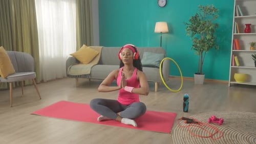 Woman Meditates in Brightly Colored Living Room