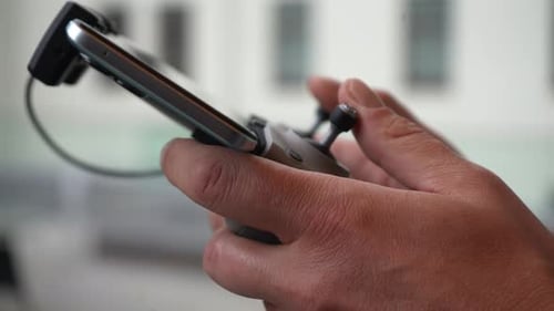 Closeup Hands of Unrecognizable Operator Male Remote Control Fpv Drone Phone Showing Signal and