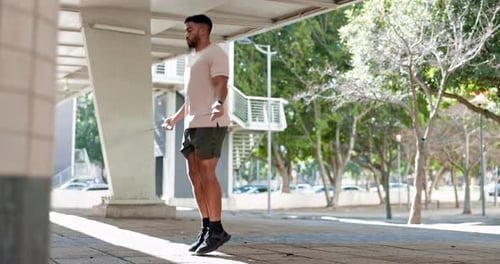 Man, skipping rope and exercise outdoor in city for a workout, jump or training