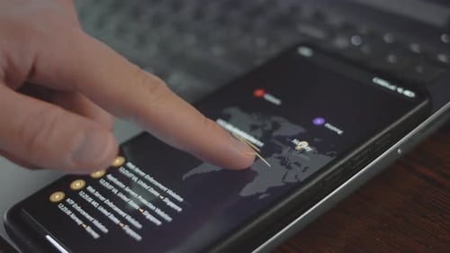 Finger Interacts with Cybersecurity App on Phone