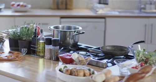 General view of kitchen countertop and hob with spices and utensils with copy space