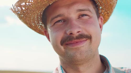 Portrait of Happy Male Caucasian Farmer Looking at the Camera with the Golden Wheat Field on the