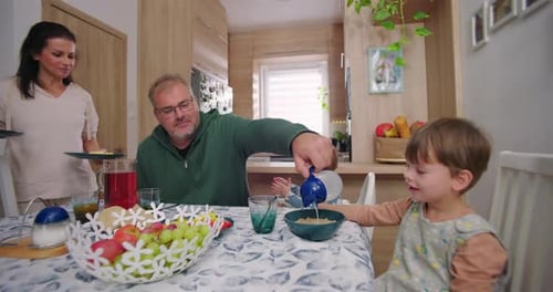 Family Enjoying Breakfast Together in Bright Home Kitchen