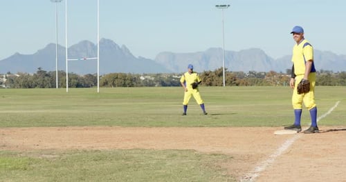 Grounder prompting infielder scooping dirt throwing to pitcher at first securing out with glove