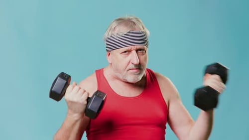 Gray Haired Man Pumping Dumbbells