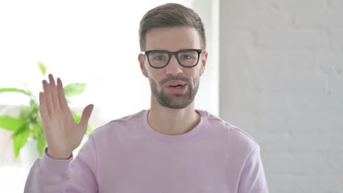 Portrait of Young Man Waving Welcoming