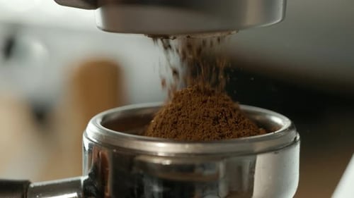 Coffee Grounds Falling into Portafilter Close Up
