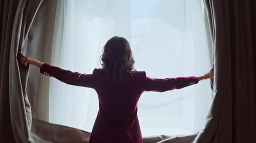 Happy Girl Opening Drapes Illuminating Modern Hotel Room Closeup Smiling Woman