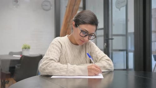 Indian Woman Writing a Letter in Office