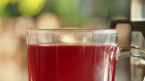 Enjoying Steaming Herbal Tea on a Sunny Morning