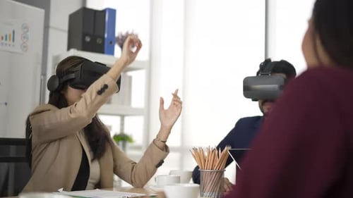 White collar worker are using VR simulator while meeting at office.
