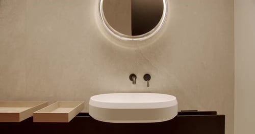 Bathroom Sink and Illuminated Mirror in Modern Home