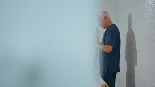 Doctor Osteopath Massaging Arm in Clinic Mature Man Treating Client Injury