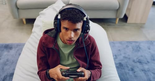 Young Man Playing Video Game at Home