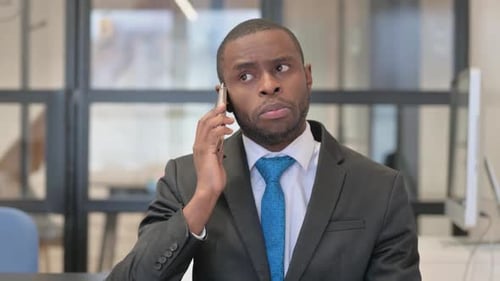 Professional Adult Talking on Smartphone in Office Setting