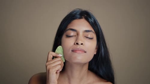 Woman Uses Crystal Tool for Facial Massage