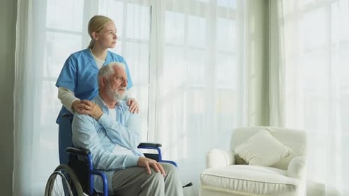 Senior Man in Wheelchair with Supportive Young Woman
