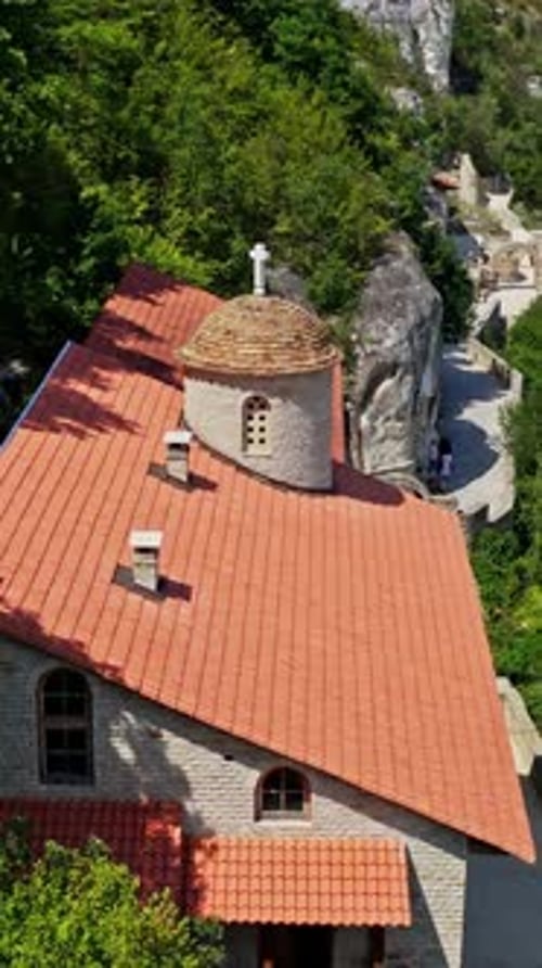 Monastery Building On Rock. Drone flight over mountain rock monastery. Vertical video