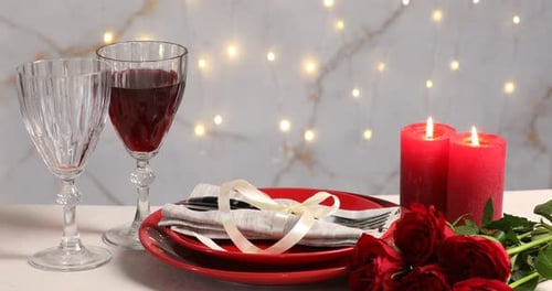 Woman setting table for festive dinner indoors, closeup