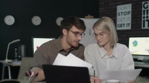 Young business team collaboration on project at night in dark modern office