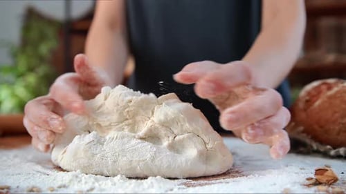Woman Kneading Dough for Bread Pasta or Pie Closeup View of Female Hands on Kitchen Table Cooking