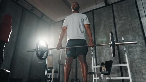 Man Do Deadlift with Barbell in Hands African American Guy Exercising Making Squats Holding Heavy