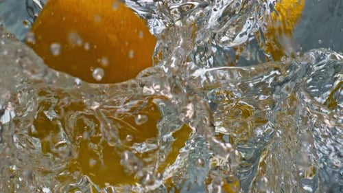 Lemons Splashing Refreshingly in Water Creating Bubbles
