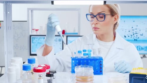 Focused Woman Scientist Working in Bright Lab