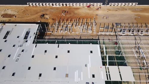 Construction Site with Steel Frame Structure of Warehouse Building Aerial View