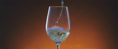 Pouring White Wine into a Wine Glass