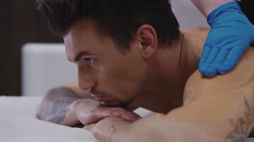 Man Receives a Relaxing Back and Shoulder Massage