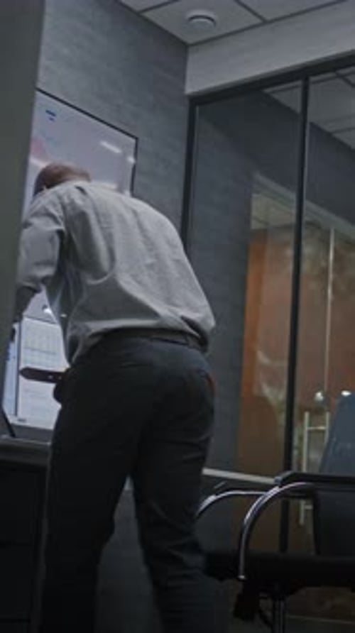 Man Celebrates Success in Modern Office