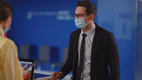 Businessman giving travel documents at airport check-in