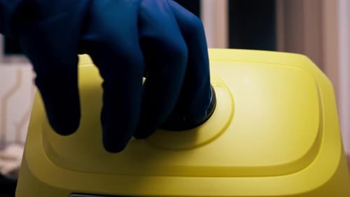 Turning on a Yellow Steam Cleaner