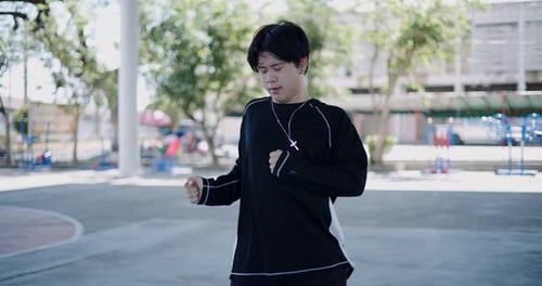 Confident young man practicing freestyle hip hop dance.