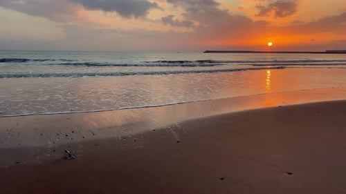 Sunset painting the barbate beach in warm hues at dusk