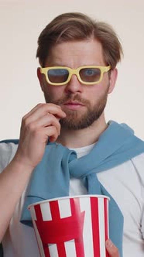 Man with 3D Glasses Eating Popcorn