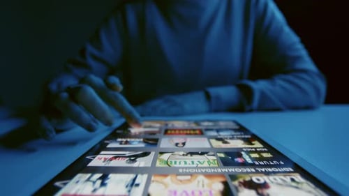 Woman Scrolling through Streaming Service in Tablet
