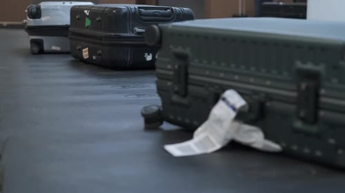 Luggage on Carousel in Busy Airport Terminal
