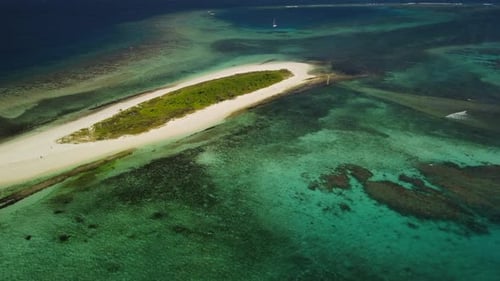 A small island, part of the archipelago of the Isle of Pines in New Caledonia - aerial parallax view