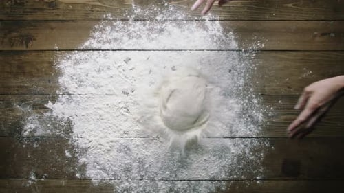 Baker Throws Dough Onto Wooden Table Upper View Slow Motion