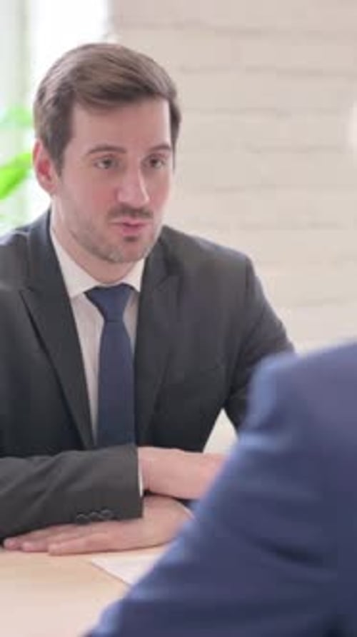 Businessman Discussing Work with Senior Old Businessman in Office, vertical video