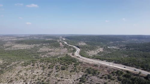 Cars drive along the Devil's Backbone through the Texas Hill Country
