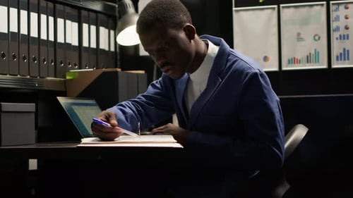 Professional Man Working Late at Office Desk