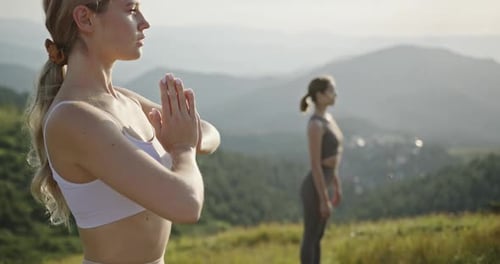 Women Practicing Yoga on Mountain Hilltop