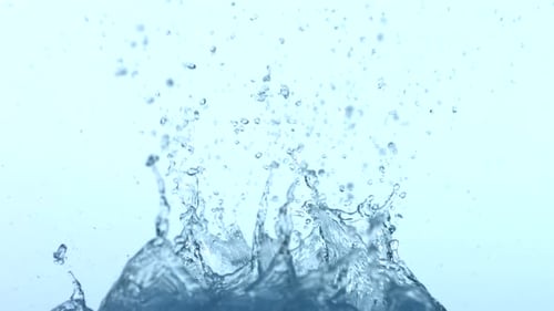 Ice Cubes Falling into Water Creating Splashes